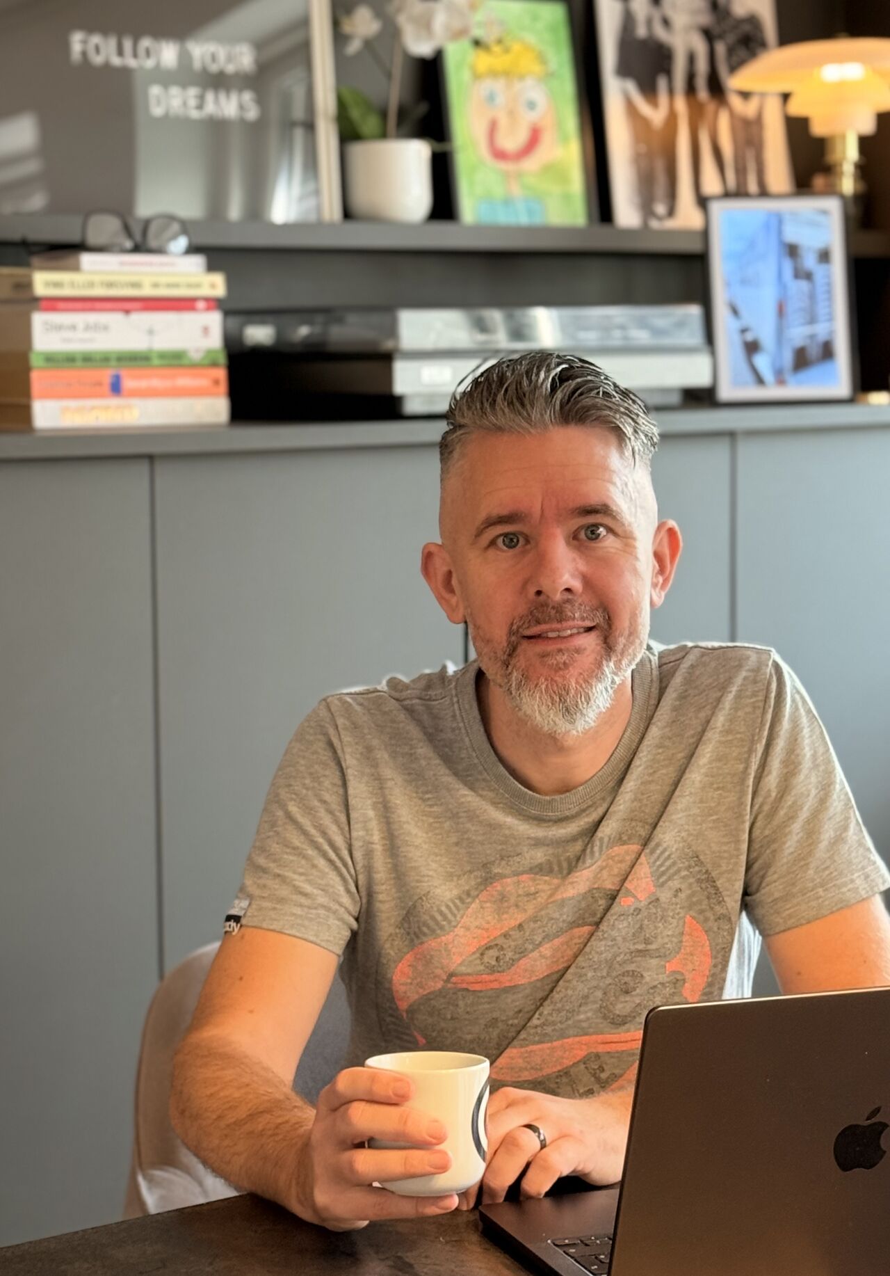 Thomas Medard sitting with a coffee at his laptop